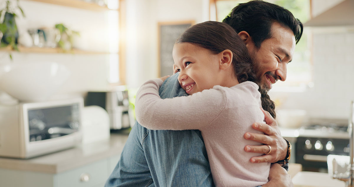 little girl hugging father